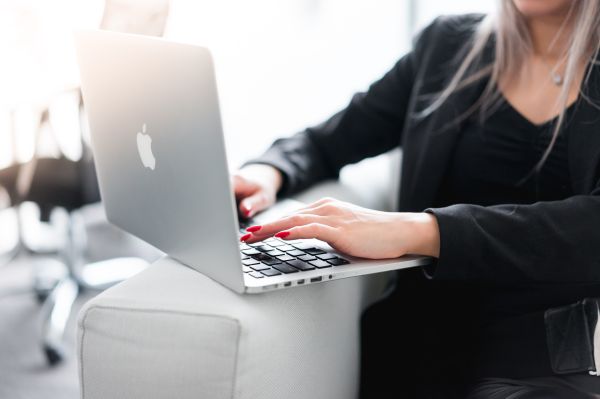 Business Woman Using Her Laptop on a Sofa Free Photo