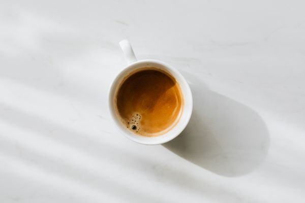 Cup of Coffee on a White Table Free Photo