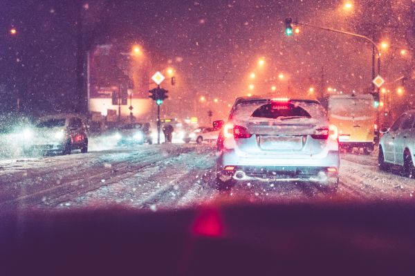 Driving in Evening Traffic Jam and Snow Calamity Weather Free Photo