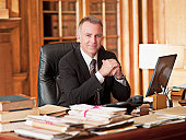 Smiling lawyer sitting at desk in office