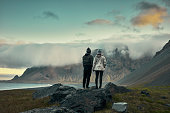 Multi ethnic couple on icelandic coast. Admiring the view