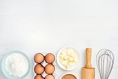 Baking ingredients and kitchen utensils on white background