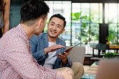 Coworkers having an informal meeting in a modern office