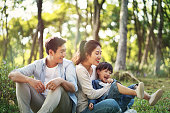 asian family with one child having fun in the woods