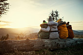 Mother and kids enjoying sunset in mountains