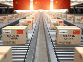 Made in China. Cardboard boxes with text made in China and chinese flag on the roller conveyor.