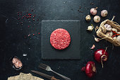 Raw minced beef burgers with spices layout