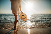 Woman's legs splashing water on the beach