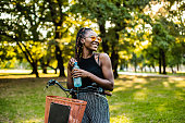 Woman on a bike drinking water