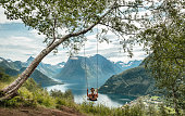 Woman swinging into nature in Norway.