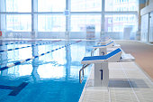 fragment of the interior of an indoor sports pool with a row of diving boards