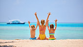 Mother with children on tropical seashore