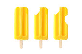 Yellow ice pops with increasing number of bites removed isolated on white