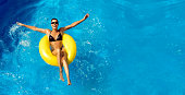 Happy laughing young woman enjoying the water park