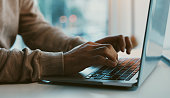 Shot of an unrecognizable businessman working on his laptop in the office