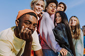 Multiracial group of young friends bonding outdoors