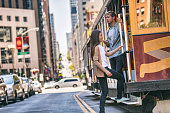 San Francisco cable car tram people tourists taking the popular tourist attraction tramway of the Powel-Hyde California, USA travel