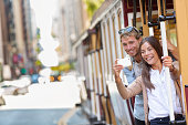 San Francisco cable car couple taking phone selfie