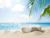 Summer sand and tropical sea background with abstract stone podium