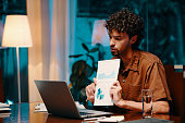 Businessman Showing Report at Online Meeting