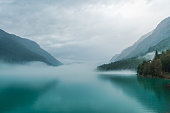 Scenic view of lake in Norway covered in fog