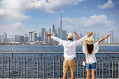 A tourist couple enjoys the panoramic view of the skyline of Dubai