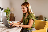 Woman using laptop when working from home office