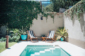 two sun chairs at swimming pool in patio