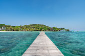 A wooden harbor bridge that stretches into the sea. On Koh Mak, Trat Province, Thailand