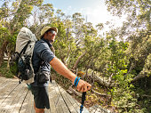 Long distance hiker arrives at camping platform