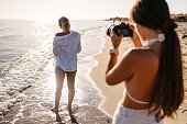 Photographer taking photos by the sea