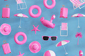 Summer beach holiday travel background, beach ball, flamingo, sunglasses, airplane, starfish, inflatable ring