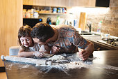 family kneads the dough