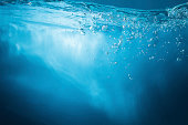 Abstract blue background. Water with sunbeams