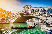 Gondola on Canal Grande with Rialto Bridge at sunset, Venice