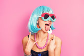 Pop girl portrait wearing weird sunglasses and blue wig