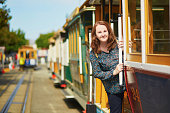 Tourist taking a ride in cable car in San Francisco