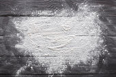 Baking concept on wood background, sprinkled flour with copy space