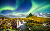 Aurora over Kirkjufell and waterfall at night