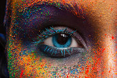 Eye of model with colorful art make-up, close-up