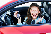 Happy woman in a new car