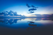 clouds reflecting in the ocean, bali island, indonesia