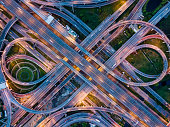 Top view of Highway road junctions at night. The Intersecting freeway road overpass the eastern outer ring road of Bangkok, Thailand.