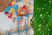 picnic basket and food. Green meadow with flowers. Spring in the Netherlands. Holidays. View from above.