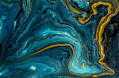 Marble abstract acrylic background. Blue marbling artwork texture. Agate ripple pattern. Gold powder.