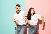 A couple of young man and woman dancing hip-hop at studio