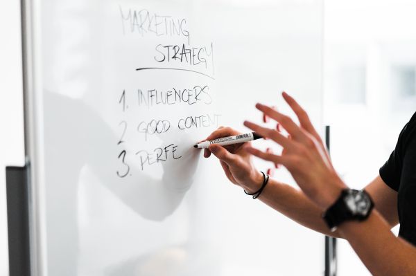 Marketing Expert Explaining New Marketing Strategy to Coworkers Free Photo