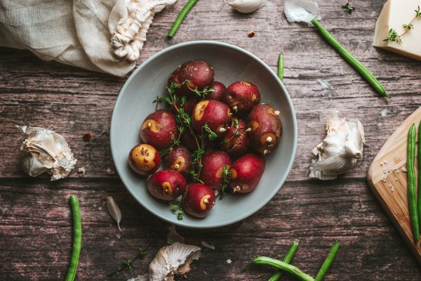 Red Potatoes with Thyme on a Rustic Table Free Photo