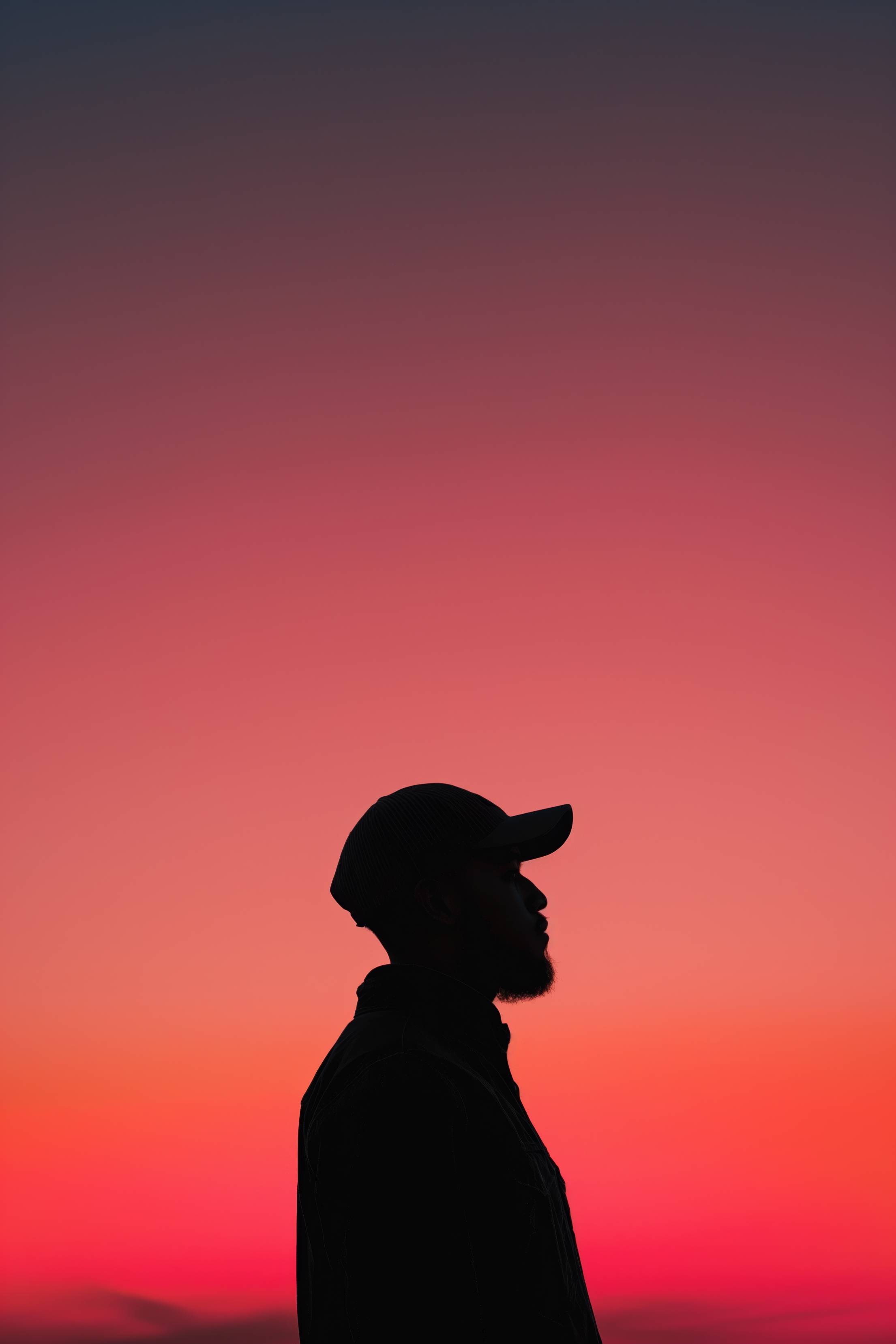 Silhouette of a Guy With a Cap at Red Sky Sunset Free Image