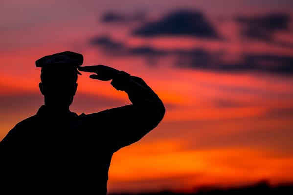 Silhouette of a Soldier Saluting at Red Sky Free Image